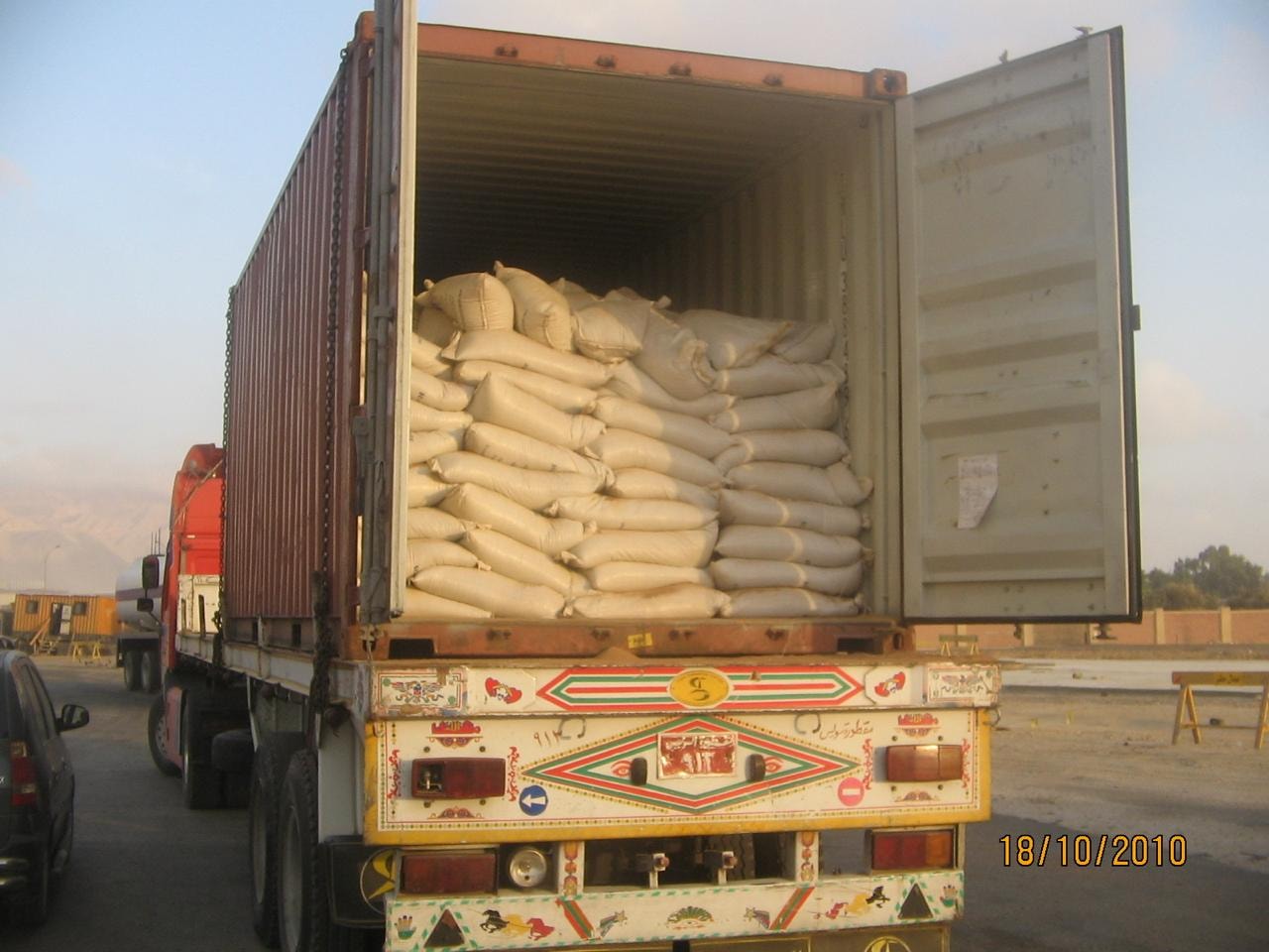 Shipping container loaded with bagged minerals ready for export — Al Karma Group company archive